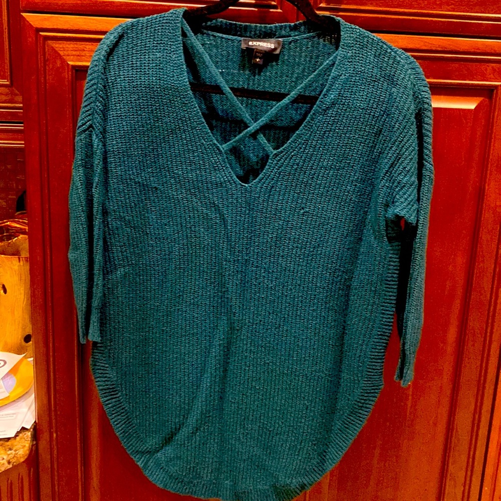 Rich emerald green express light sweater. Criss cross detail